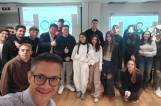 Business students engage with international HR expert on core management principles during virtual session